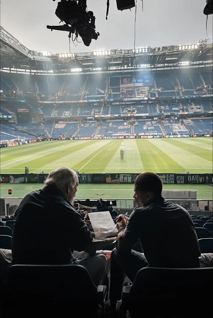Sports infrastructure architects reviewing structural design plans
